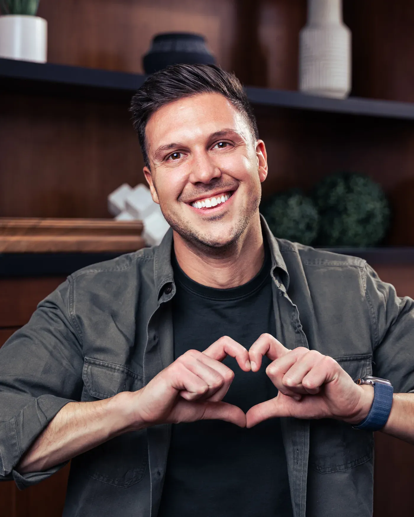 Grant Winns, co-founder and CEO of Yuna, making a heart shape with his hands
