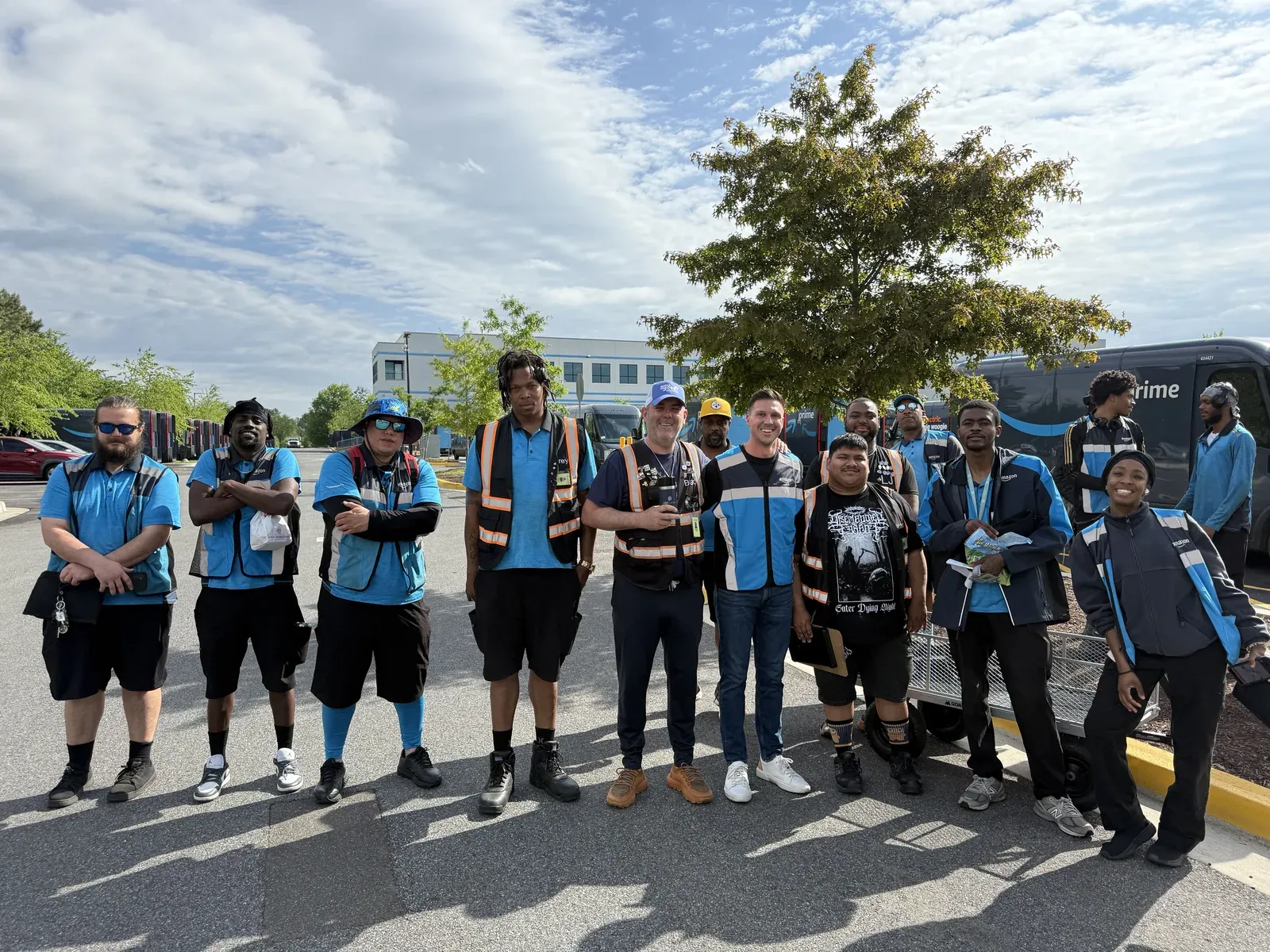 A DSP delivery team in Amazon vests with Yuna CEO Grant Winns outside their delivery station on launch day