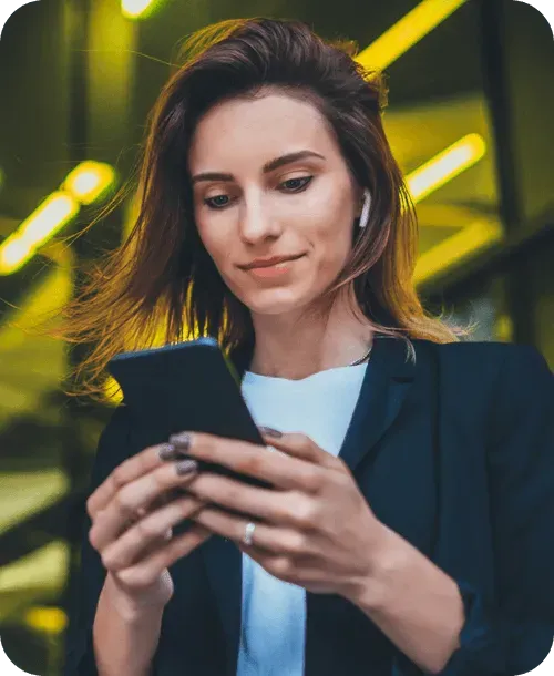 Woman smiling while using the Yuna app on her phone