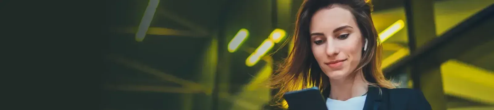 Woman smiling while using the Yuna app on her phone