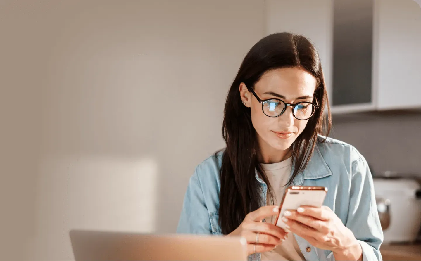 Woman smiling while using the Yuna app on her phone