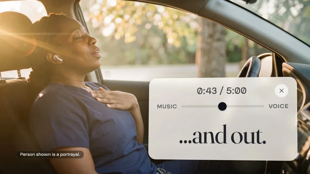 Film still: the nurse from the opening scene in her car in morning sun, hand on her chest, a meditation player reading and out