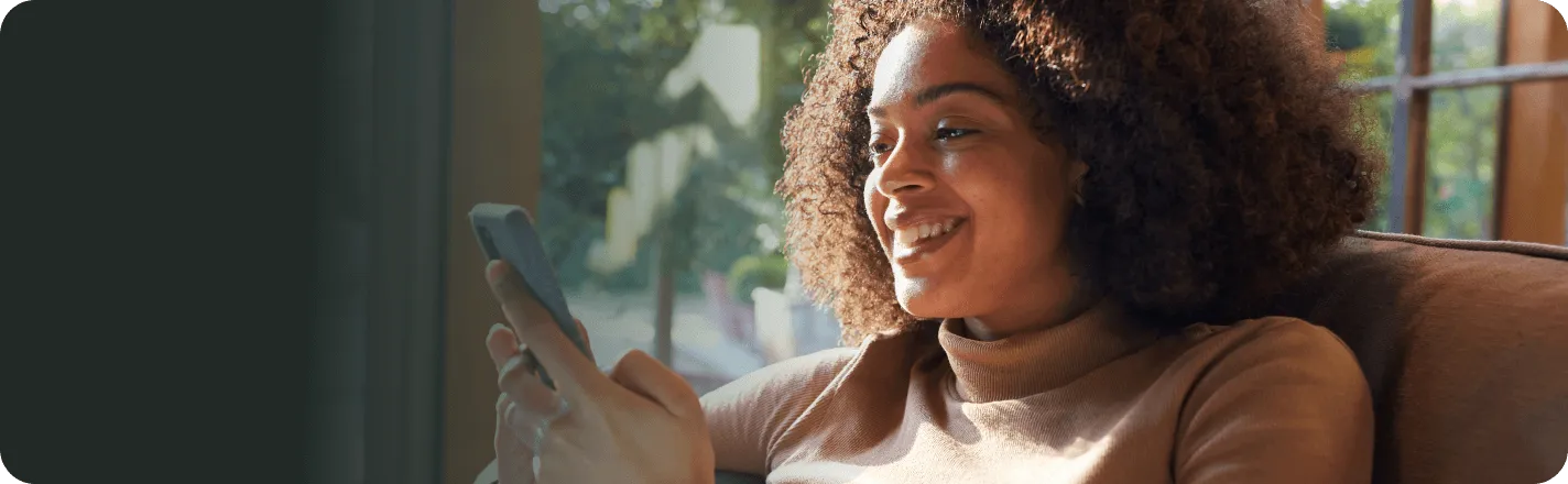 woman smiling using phone